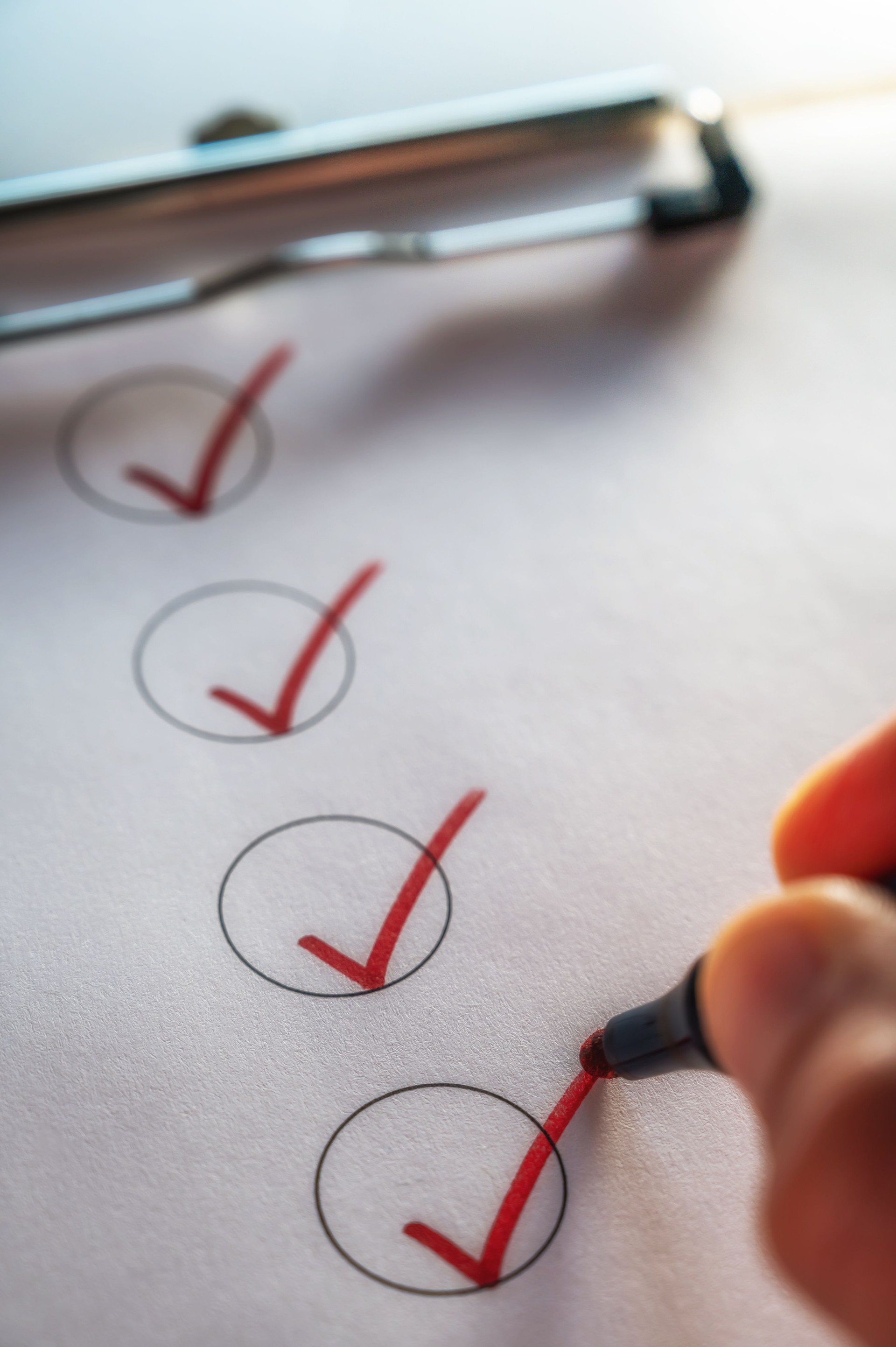 Checking off a to-do list on a clipboard with a red check mark